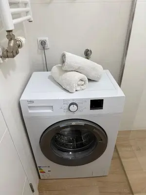 a washing machine with two towels on top of it at Kutak mira in Doboj