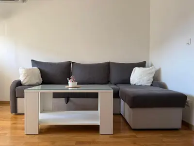 a living room with a couch and a table at Kutak mira in Doboj
