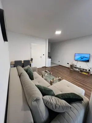 a living room with a couch and a tv at TM Studio Apartment Prijedor in Prijedor