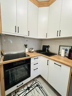 a kitchen with white cabinets and a sink at Apartment Stepanova in Banja Luka