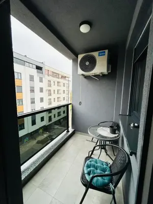a small balcony with a table and a window at Apartment Stepanova in Banja Luka