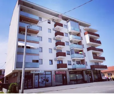 a white building with balconies on the side of it at Dunja Doboj in Doboj