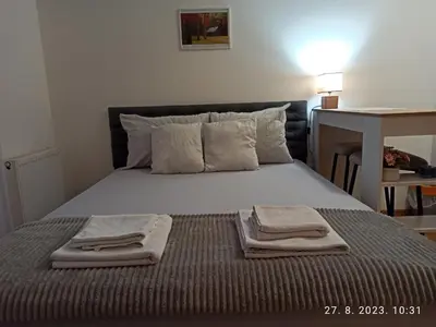 a bedroom with a bed with towels on it at Dunja Doboj in Doboj