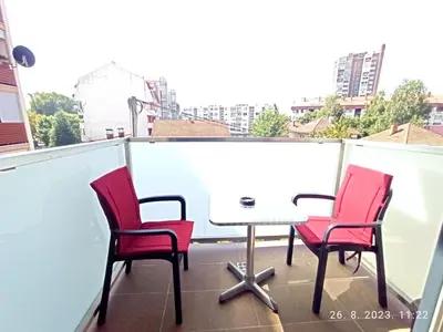 a table and four chairs on a balcony at Dunja Doboj in Doboj