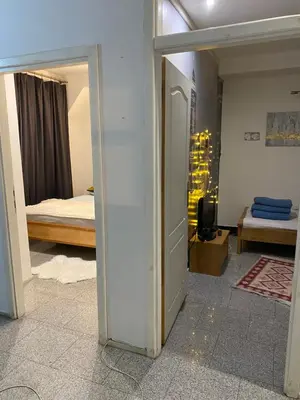 a room with a bedroom with a bed and an open door at Adna Art Apartment in Bihać