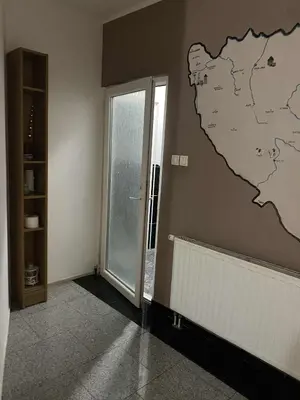 a room with a map ofitzerland on the wall at Adna Art Apartment in Bihać