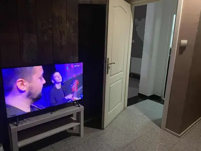 a flat screen tv sitting on top of a table at Adna Art Apartment in Bihać