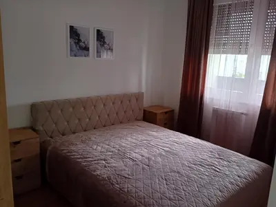 a small bedroom with a bed and a window at Apartman Teo in Banja Luka