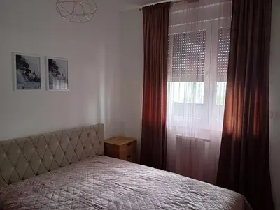 a bedroom with a bed and a window at Apartman Teo in Banja Luka