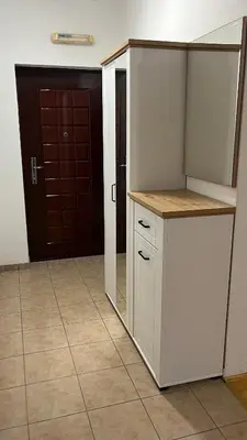 a kitchen with a white refrigerator and a door at Stan na dan Šamac in Bosanski Šamac