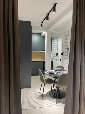 a kitchen and dining room with a table and chairs at Apartment in the center with free parking in Banja Luka