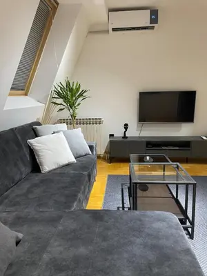 a living room with a couch and a flat screen tv at Apartment in the center with free parking in Banja Luka