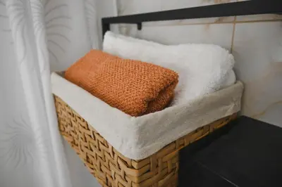 a basket filled with white towels in a bathroom at Villa Fluviale in Jezero