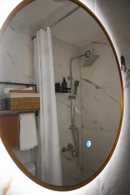 a bathroom mirror with a shower and a shower curtain at Villa Fluviale in Jezero