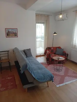 a living room with a couch with a blanket on it at Beatiful BL in Banja Luka