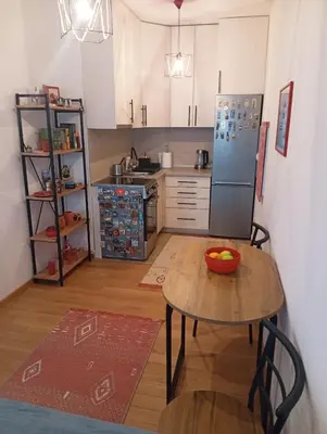a kitchen with a table and a refrigerator at Beatiful BL in Banja Luka