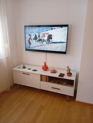 a flat screen tv on top of a white entertainment center at Beatiful BL in Banja Luka