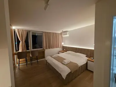 a hotel room with a bed and a desk at Studio apartman Adria downtown in Banja Luka