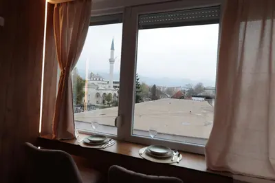 a window with a view of a city skyline at Studio apartman Adria downtown in Banja Luka