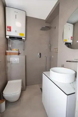 a bathroom with a white toilet and a sink at Studio apartman Adria downtown in Banja Luka