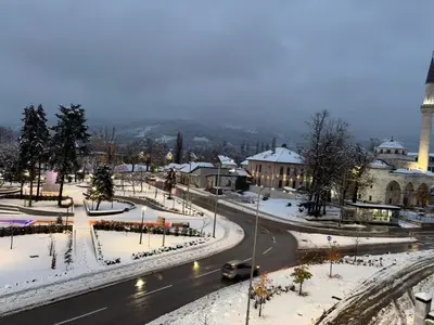a street in a city with snow on the ground at Studio apartman Adria downtown in Banja Luka