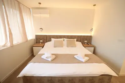 a bedroom with a bed with two towels on it at Studio apartman Adria downtown in Banja Luka