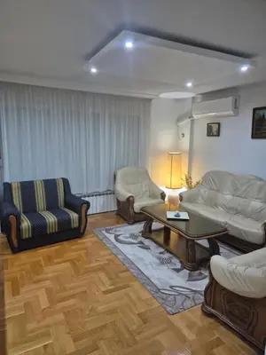 a living room with two couches and a coffee table at Apartment D in Krndija