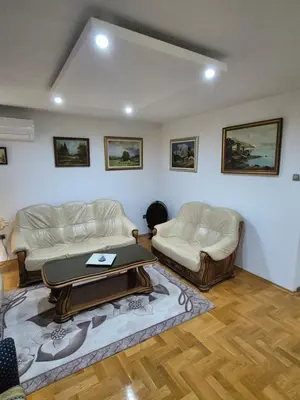 a living room with two couches and a table at Apartment D&D in Krndija