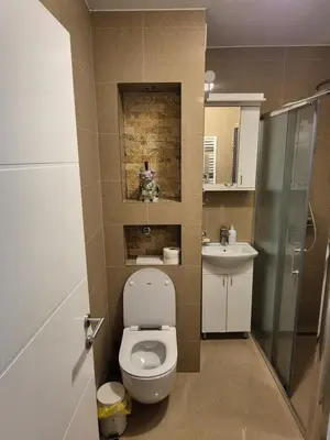 a small bathroom with a toilet and a sink at Apartment D&D in Krndija