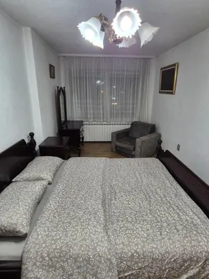 a bedroom with a large bed and a couch at Apartment D&D in Krndija