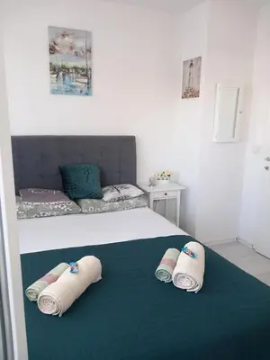 a bedroom with a bed with three towels on it at Apartman Ana in Banja Luka