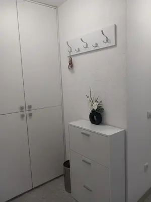 a room with white cabinets and a shelf with birds on it at Apartman Ana in Banja Luka