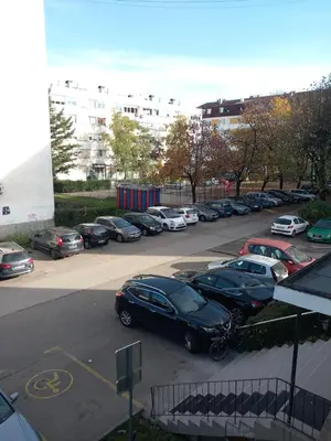 a parking lot with a bunch of cars parked at Apartman Ana in Banja Luka
