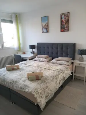 a bedroom with a large bed with two pillows on it at Apartman Ana in Banja Luka