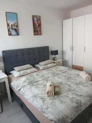 a bedroom with a large bed with towels on it at Apartman Ana in Banja Luka