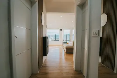 a hallway leading to a living room with a couch at TheLuxPenthouseBugojno in Bugojno