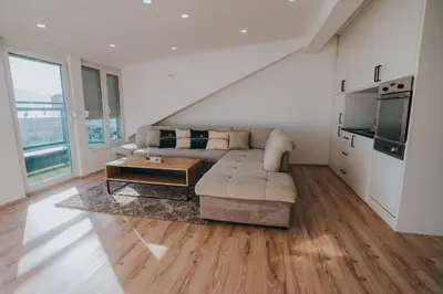 a living room with a couch and a table at TheLuxPenthouseBugojno in Bugojno