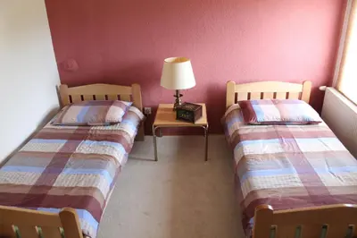 a room with two beds and a table with a lamp at Apartment M in Livno