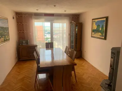 a dining room with a wooden table and chairs at Apartment M in Livno