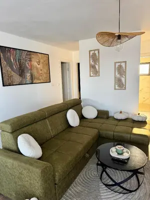 a living room with a couch and a table at Aurora Noir Retreat in Banja Luka