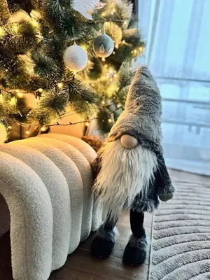 a stuffed cat standing next to a christmas tree at Aurora Noir Retreat in Banja Luka