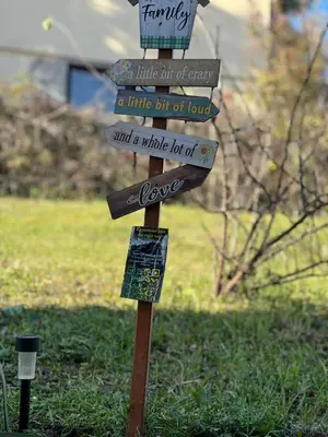 a sign in the grass with some signs on it at Vila jajcegrad in Jajce