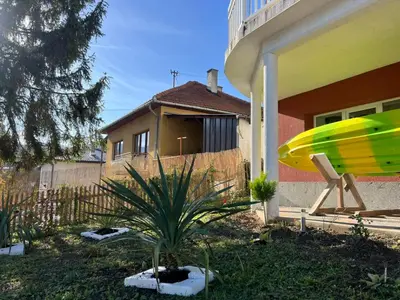 a yellow surfboard sitting on the side of a house at Vila jajcegrad in Jajce