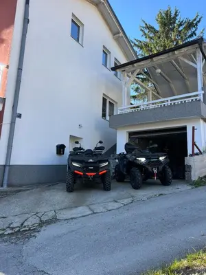 two atvs and two quad bikes parked outside a building at Vila jajcegrad in Jajce