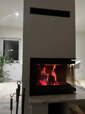 a fireplace with a fire in a living room at Vila jajcegrad in Jajce