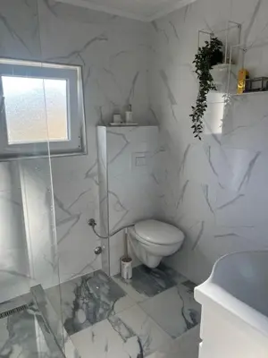a bathroom with a toilet and a glass shower at Vila jajcegrad in Jajce