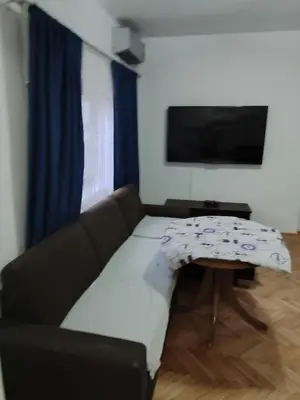 a living room with a couch and a table at Happy in Banja Luka