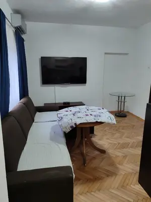 a living room with a couch and a table at Happy in Banja Luka