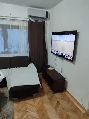 a living room with a couch and a flat screen tv at Happy in Banja Luka