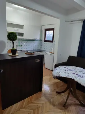 a kitchen and a living room with a table at Happy in Banja Luka